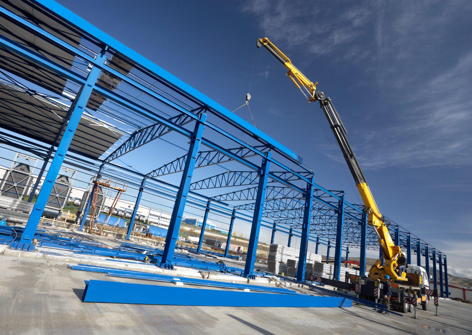 Steel frame rising with a tower crane